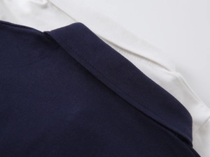 Detailed close-up of the knit cotton collar and neat stitching on a boys' polo shirt