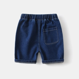 Detail of elastic waistband and back pocket stitching on dark blue denim shorts