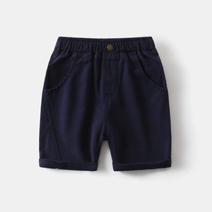 Close-up of boys navy casual shorts featuring elastic waist and metal button detail