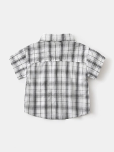 Back view of boys black and white plaid short sleeve cotton shirt with casual yoke detail