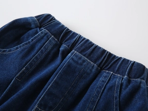 Close-up of boys deep blue denim shorts featuring elastic waistband and durable twill fabric