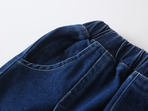 Detailed close-up of dark blue denim shorts with elastic waistband and contrast stitching