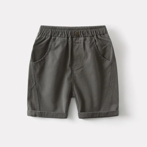 Detailed close-up of boys casual cotton shorts with elastic waistband and button accent