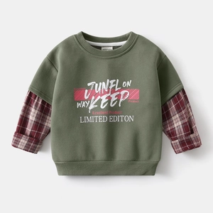 Detail of boys olive green faux layered sweatshirt with red plaid sleeves and printed text
