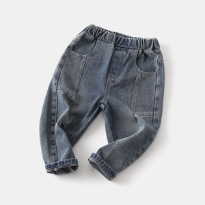 Detail of boys vintage blue jeans showing elastic waist and stitched patchwork texture