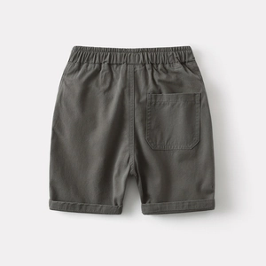 Detail of dark grey boy's cotton shorts showing elastic waistband and back pocket