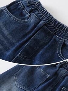 Front and back view of dark blue boys' denim jeans with elastic waist and white stitching