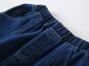 Detail of boys dark blue denim shorts with elastic waistband and high-quality stitching