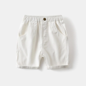 Detail of boys white cotton casual shorts showing elastic waist and metal button