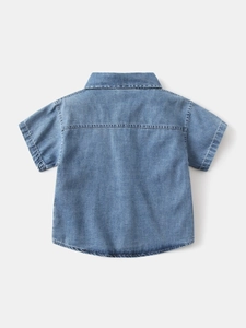 Back view of boys short-sleeve denim shirt in classic washed blue cotton fabric
