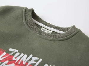 Detail of ribbed neckline and graphic print on army green cotton sweatshirt for boys