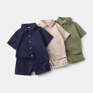 Detail of short-sleeve cotton-linen shirts and shorts set in blue, apricot, and green