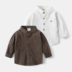 Detail of white and brown cotton linen shirts showing collar and button textures