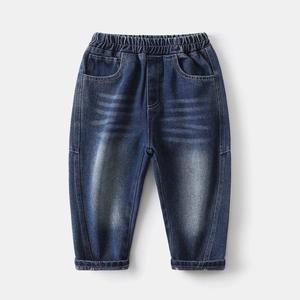 Detail of boys denim pants with elastic waistband and distressed whiskering effect