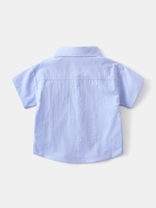 Back view of light blue short-sleeved cotton linen shirt for boys with natural texture