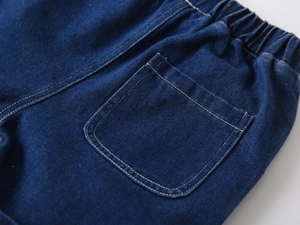 Close-up of boys' dark blue denim shorts featuring elastic waistband and contrast stitching