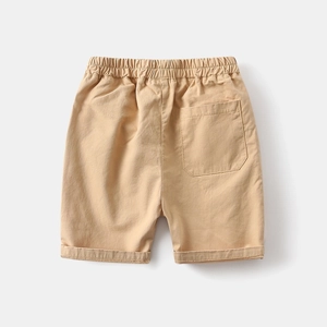 Detail of boys khaki cotton shorts showing elastic waistband and back pocket