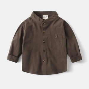 Close-up of caramel cotton kids' shirt featuring a small stand collar and button chest pocket
