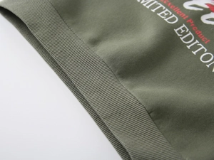 Close-up of army green ribbed hem and cuff with Excellent Product printed lettering
