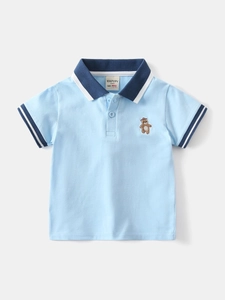 Boy's light blue short sleeve polo shirt with bear embroidery and navy collar