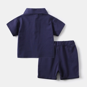 Detailed flat lay of boys' navy blue cotton knit polo shirt and elastic shorts set