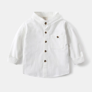 Detail of white cotton shirt featuring a stand collar and textured brown buttons
