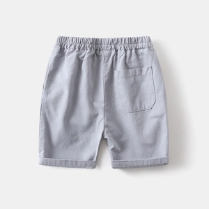 Detail of light gray kids shorts featuring elastic waist and embroidered back pocket
