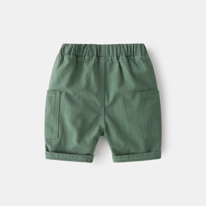 Detail of boys green cargo shorts featuring elastic waistband and large side pockets