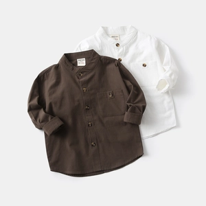 Detailed flat lay of boys' solid cotton shirts with V-neck and wood-texture buttons