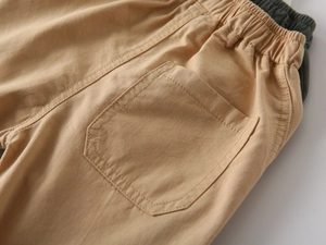 Detailed view of kids cotton twill shorts showing elastic waist and back pocket stitching