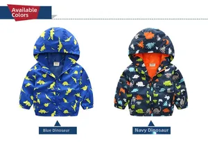 Detail view of boys windbreaker jackets in blue and navy with colorful dinosaur patterns