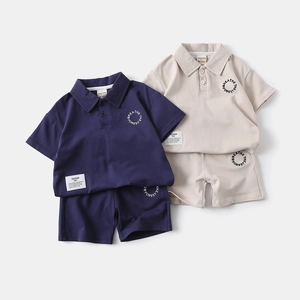 Close-up of cotton polo shirts and shorts sets in navy and beige with chest embroidery