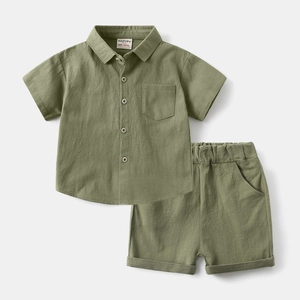 Flat lay detail of sage green boy's short-sleeve button-up shirt and shorts set