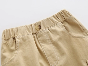 Detail of khaki cotton twill shorts with elastic waist and marble button for boys