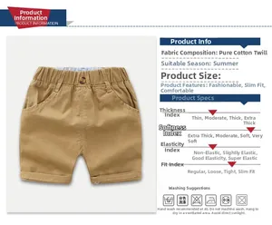 Detail of khaki cotton twill shorts showing elastic waist, button and side pockets
