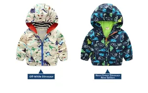 Detail of kids hooded jackets with dinosaur print in off-white and navy blue colors