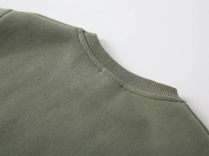 Detail shot of the olive green ribbed neckline and fine stitching on the boys' sweatshirt