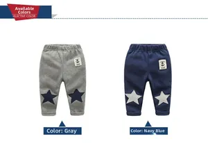 Detail of elastic waist and star patch on grey and navy blue toddler fleece pants