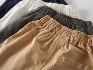 Detail of multi-color cotton cargo shorts showing elastic waistband and stitching