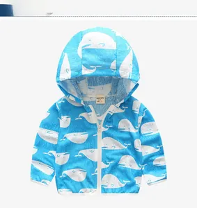 Detail of blue toddler windbreaker with white whale print and hooded zip closure