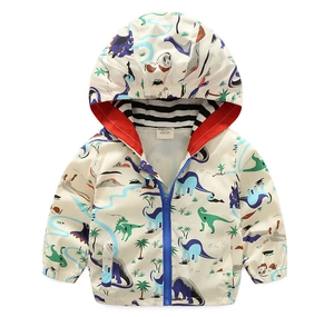 Close-up of children's white hooded windbreaker with colorful cartoon dinosaur prints