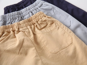 Detail of boys cotton shorts showing elastic waistband and back pocket in various colors