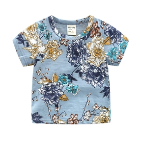Detail of baby boy light blue T-shirt with vintage floral pattern and round neck