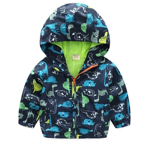 Detailed view of kids windbreaker with colorful dinosaur print and green mesh lining