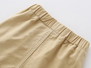 Detail of boys khaki shorts showing elastic waistband and reinforced white stitching