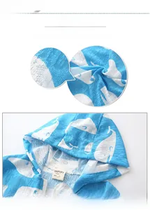 Detail of baby hooded jacket featuring blue whale print and breathable textured fabric