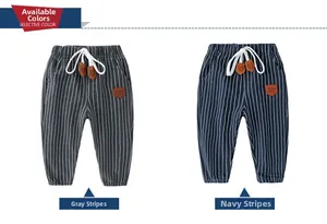 Detail of gray and navy striped kids cotton trousers with drawstring waist and leather patch