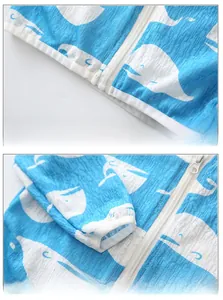 Detail view of boys' lightweight windbreaker showing whale prints and textured fabric hem