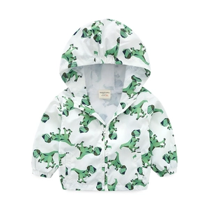 Close-up of lightweight toddler windbreaker with green dinosaur print and hood details