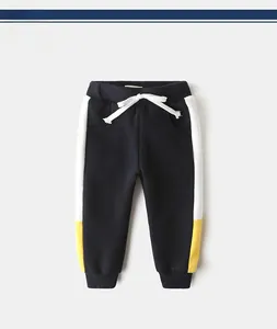 Detailed view of boys' navy fleece joggers featuring yellow and white side stripe panels